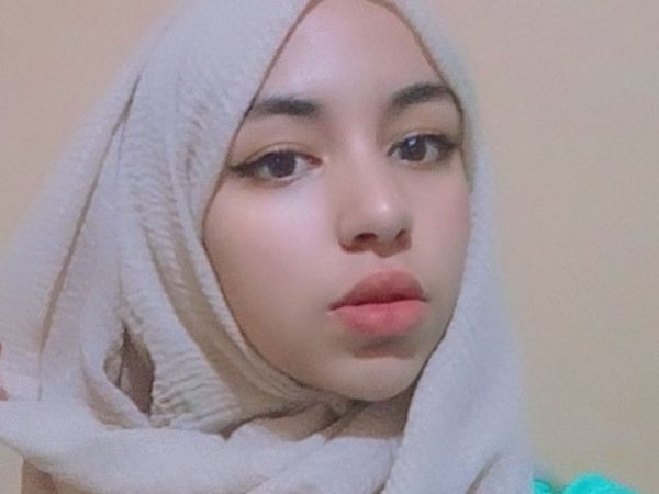 Young woman wearing a beige hijab